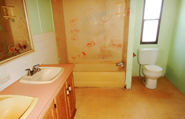 full bathroom featuring vanity,  shower combination, and toilet