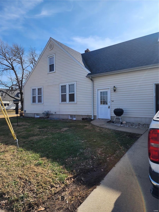 back of house featuring a lawn