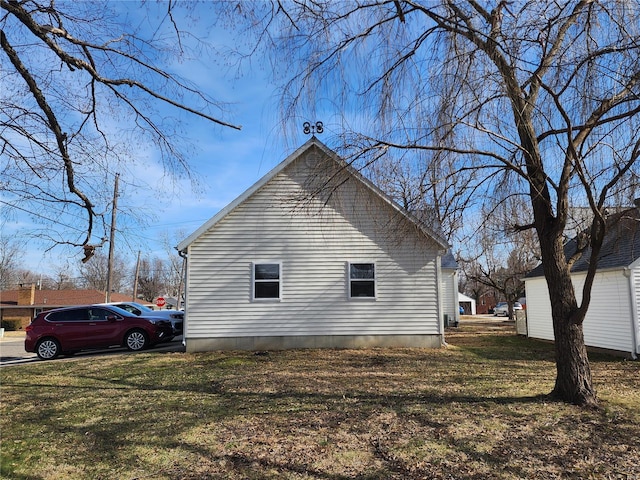 view of side of property with a lawn