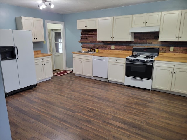 kitchen featuring white appliances, dark hardwood / wood-style flooring, wood counters, and sink