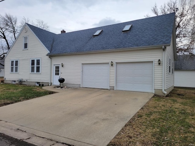 view of front of property with a garage and a front yard