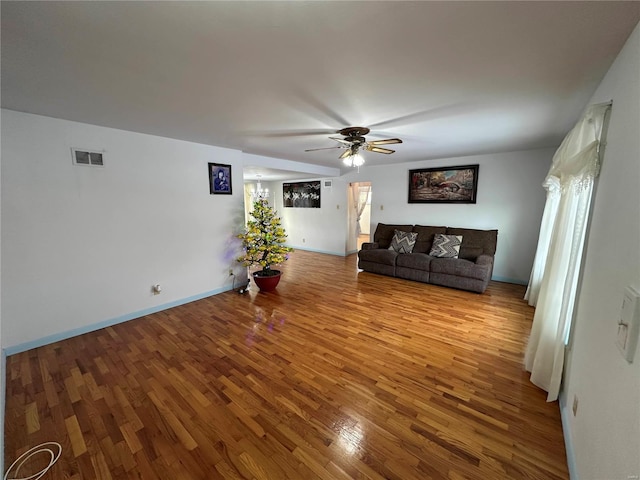 unfurnished living room featuring ceiling fan and light wood-type flooring