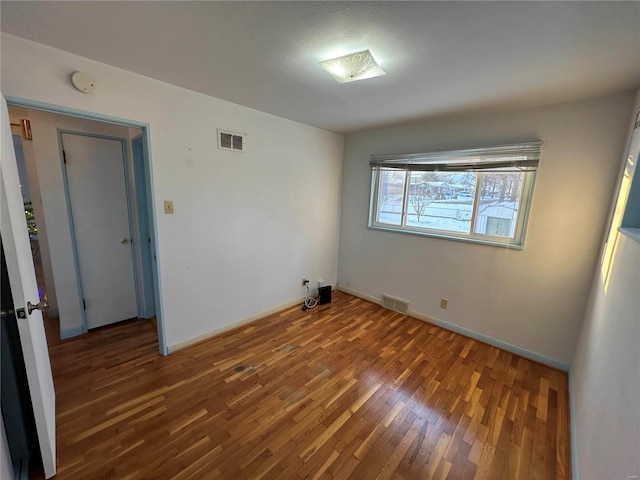 spare room with dark hardwood / wood-style flooring