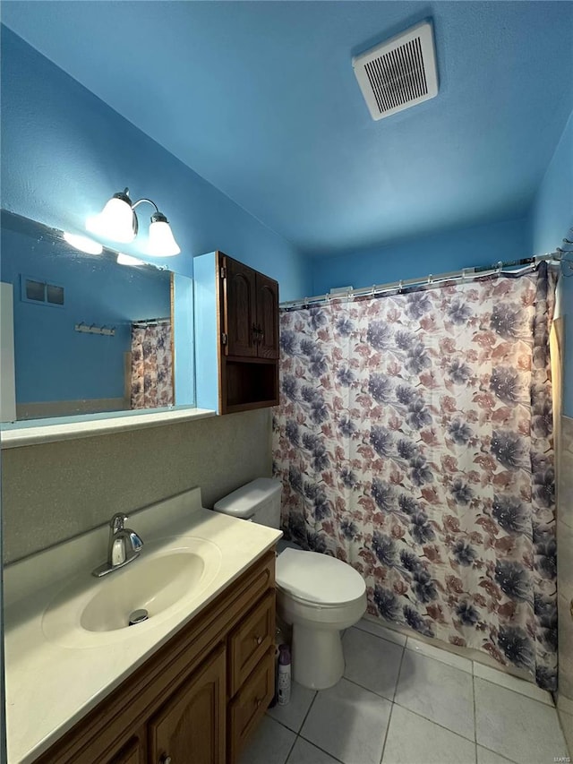 bathroom featuring vanity, toilet, and tile patterned flooring