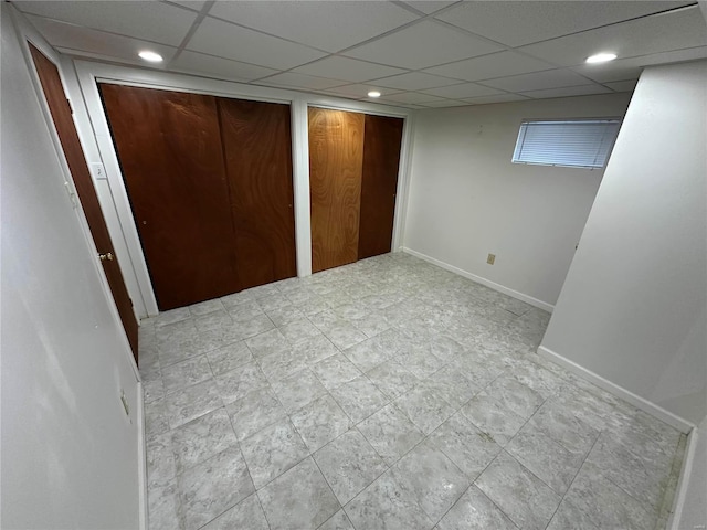 unfurnished bedroom featuring a drop ceiling