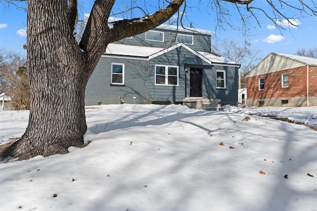 bungalow-style home featuring brick siding