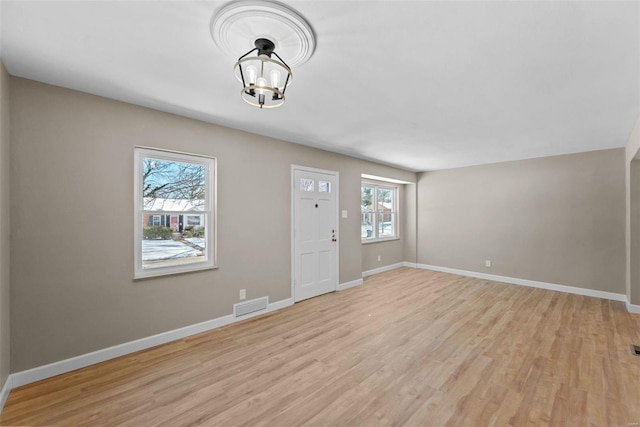 entrance foyer featuring visible vents, light wood-style flooring, and baseboards