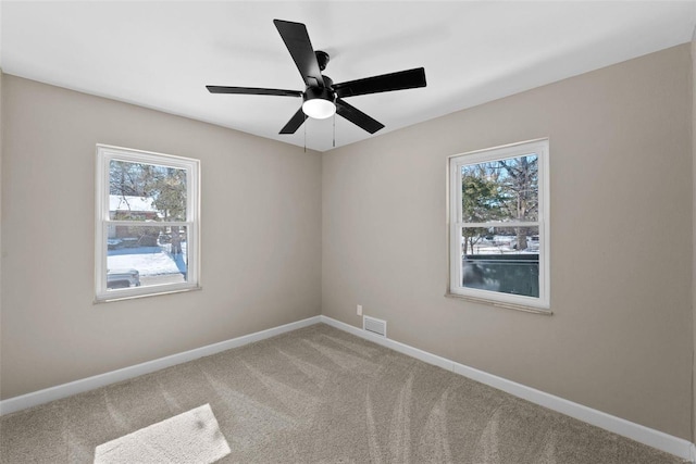 empty room with a ceiling fan, baseboards, visible vents, and carpet flooring