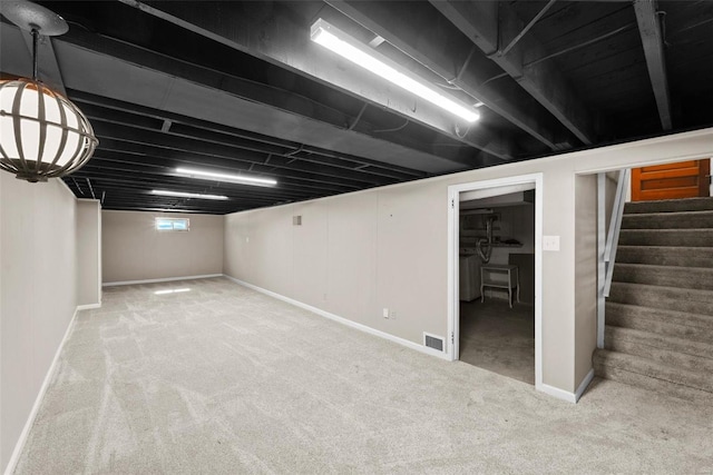 basement featuring stairs, light carpet, visible vents, and baseboards