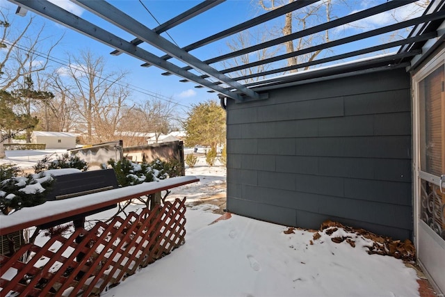 snow covered patio with a pergola