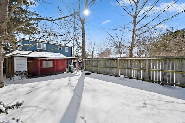 snowy yard with fence