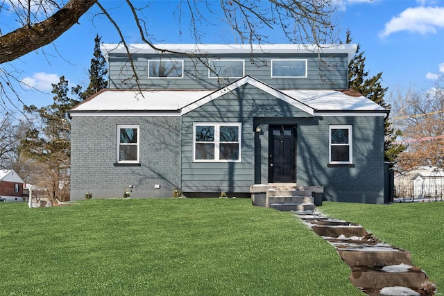 view of front of house featuring brick siding and a front lawn