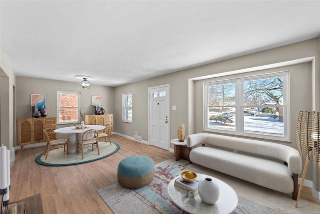 interior space with visible vents, light wood-style flooring, and baseboards