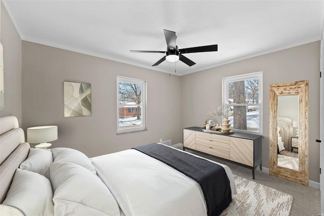 bedroom with crown molding, multiple windows, carpet flooring, and baseboards