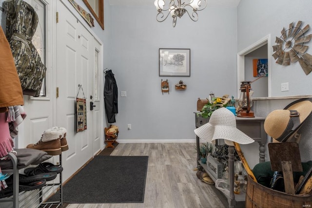 entrance foyer featuring a notable chandelier and light hardwood / wood-style floors