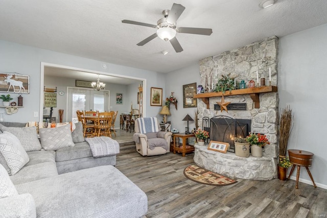 living room with hardwood / wood-style floors, a textured ceiling, a fireplace, and ceiling fan