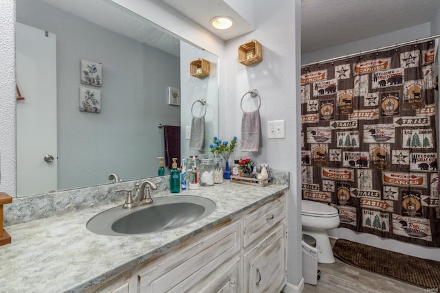 bathroom with hardwood / wood-style flooring, vanity, curtained shower, and toilet