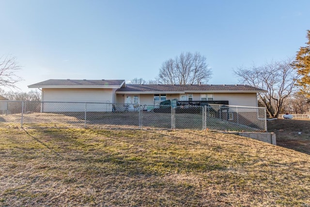 rear view of house featuring a yard