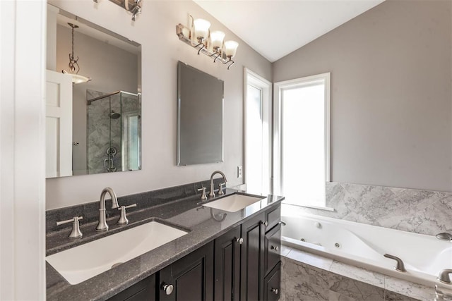 bathroom featuring vanity, lofted ceiling, and shower with separate bathtub