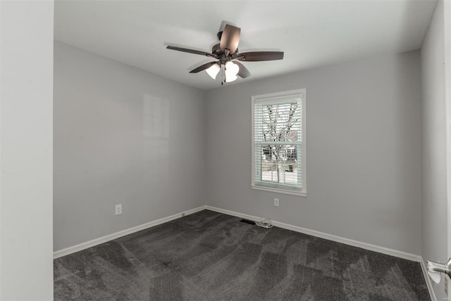 carpeted empty room featuring ceiling fan