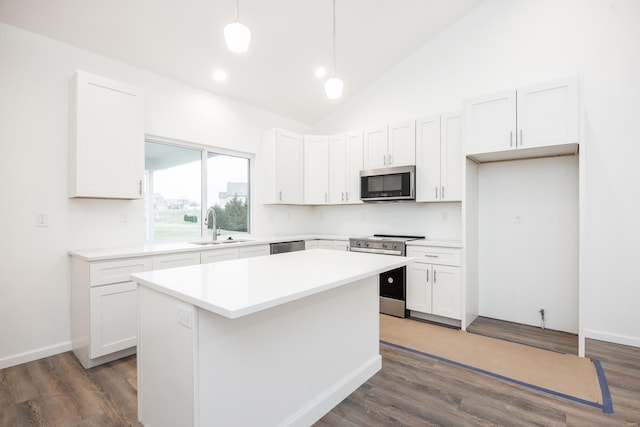 kitchen with pendant lighting, a center island, white cabinets, and appliances with stainless steel finishes