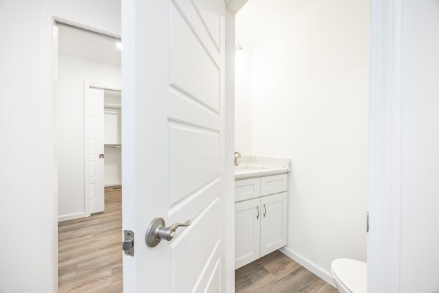 bathroom featuring vanity, hardwood / wood-style floors, and toilet