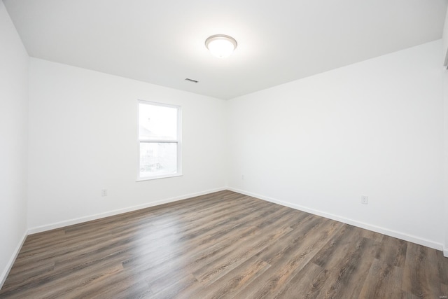 unfurnished room featuring dark hardwood / wood-style floors