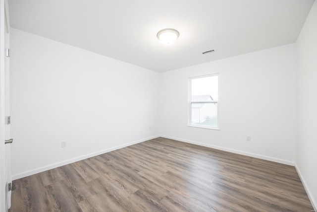 unfurnished room with hardwood / wood-style floors