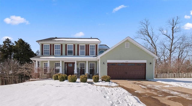 view of front of property featuring a garage, driveway, a porch, and fence