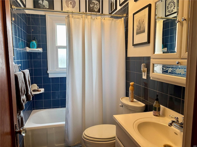 bathroom featuring toilet, shower / bathtub combination with curtain, tile walls, and vanity