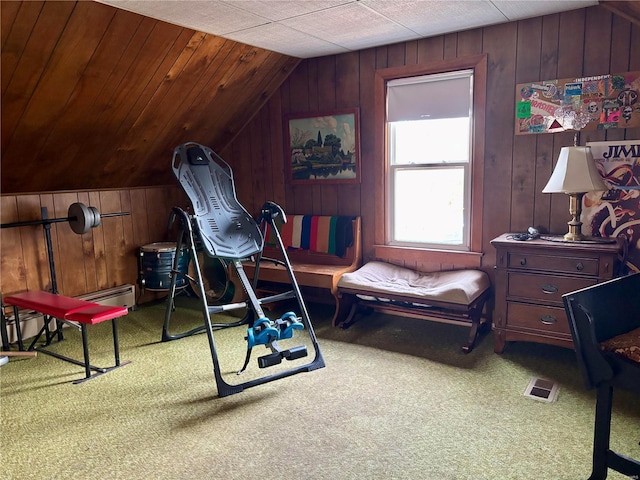 interior space with wood walls, visible vents, and vaulted ceiling