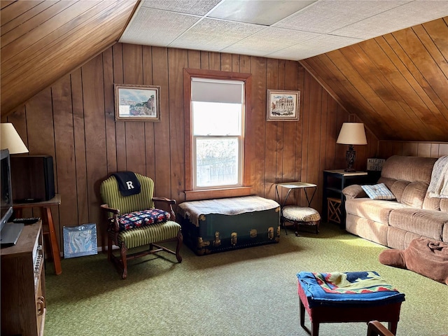 interior space with carpet, wooden walls, and vaulted ceiling