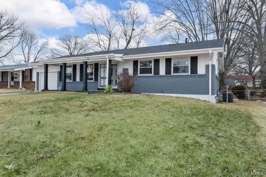 ranch-style house with cooling unit and a front lawn