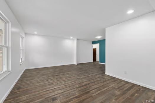 spare room with dark hardwood / wood-style flooring