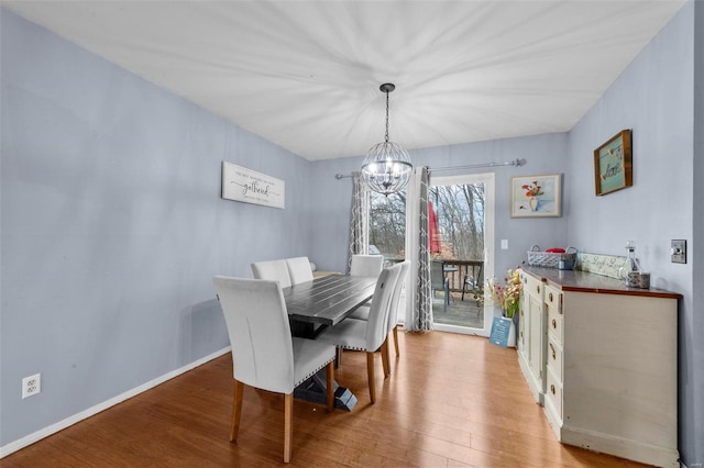 dining room with a chandelier and light hardwood / wood-style floors