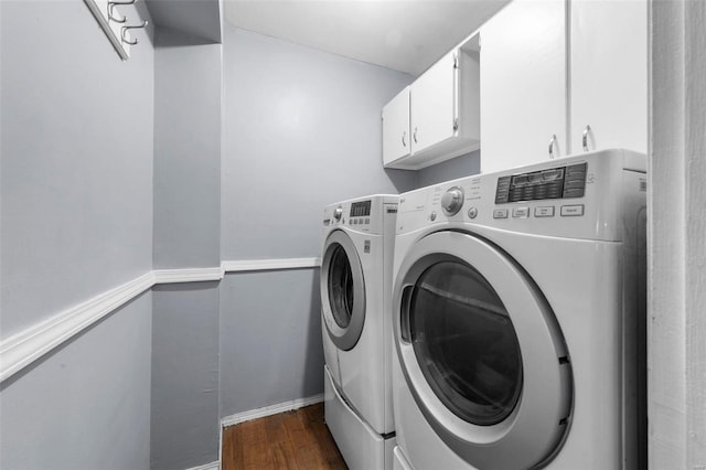 clothes washing area with cabinets, dark wood-type flooring, and independent washer and dryer