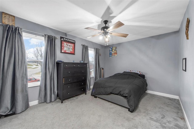 bedroom featuring light colored carpet and ceiling fan