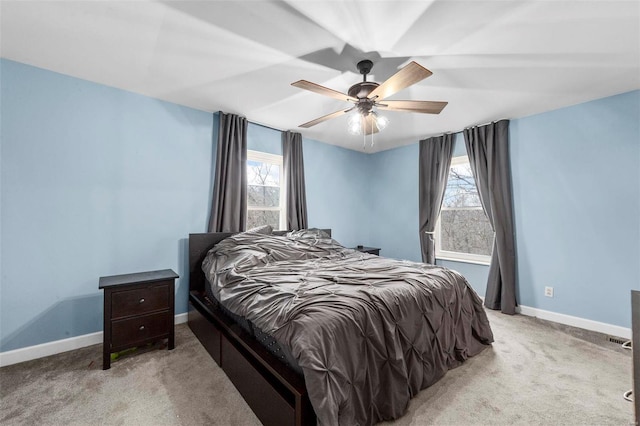 bedroom featuring light colored carpet and ceiling fan