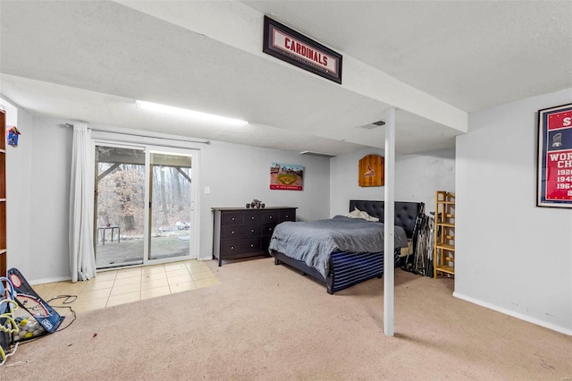 bedroom featuring light carpet, access to outside, and a textured ceiling