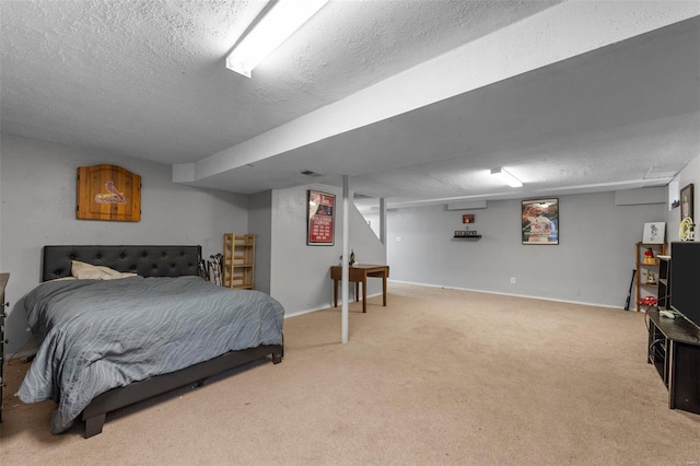 bedroom with light carpet and a textured ceiling