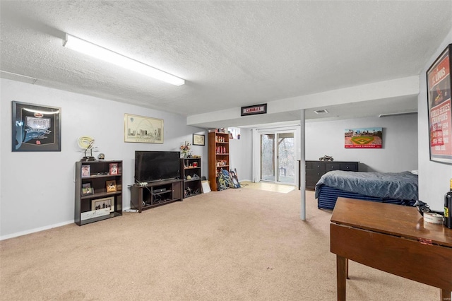 bedroom with access to exterior, carpet, and a textured ceiling