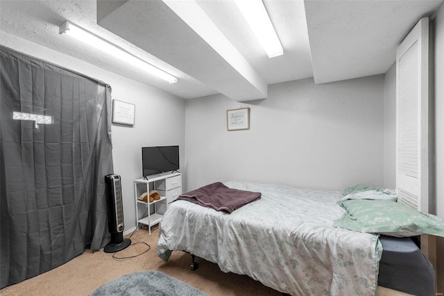 carpeted bedroom featuring a textured ceiling