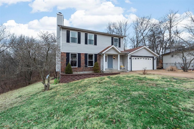 view of front of house with a garage and a front lawn