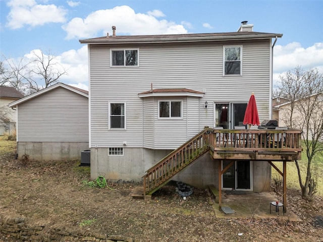 rear view of property featuring a deck