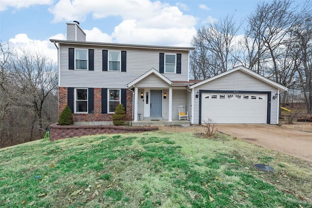 view of front of property with a garage and a front lawn