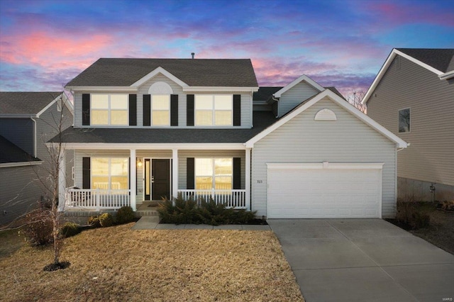 traditional home featuring a garage, covered porch, driveway, and a shingled roof