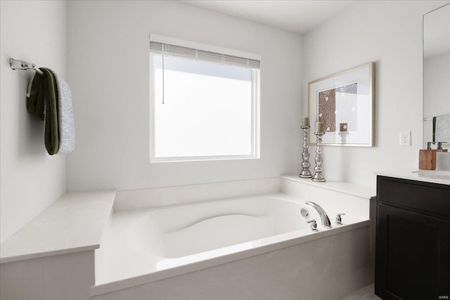 bathroom featuring vanity and a bath