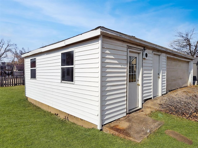 view of outbuilding with a garage and a yard
