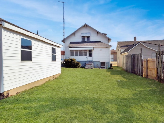 back of property with central AC unit and a lawn
