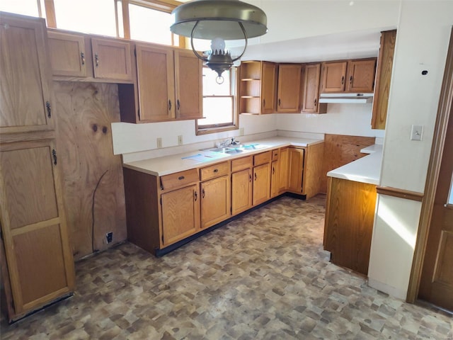 kitchen with sink and an inviting chandelier